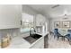 Bright kitchen featuring white cabinets, marble countertops, and a view of the pool from the window at 8420 43Rd Avenue W Dr, Bradenton, FL 34209