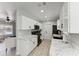 Modern kitchen featuring white cabinets, marble countertops, and stainless steel appliances at 8420 43Rd Avenue W Dr, Bradenton, FL 34209