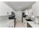 Updated kitchen showcases white cabinets, sleek black appliances, and stylish marble countertops at 8420 43Rd Avenue W Dr, Bradenton, FL 34209