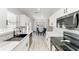 Bright kitchen with white cabinets, marble countertops, and a dining area with blue chairs at 8420 43Rd Avenue W Dr, Bradenton, FL 34209