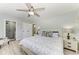 Bright main bedroom with a ceiling fan, lamps, and a private bathroom at 8420 43Rd Avenue W Dr, Bradenton, FL 34209