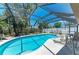 Sparkling screened-in pool with seating area and lush landscaping. Great for relaxation and entertaining at 8420 43Rd Avenue W Dr, Bradenton, FL 34209
