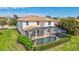 Aerial view showcases property with screened-in pool, lovely landscaping, and a durable tile roof at 8603 River Preserve Dr, Bradenton, FL 34212