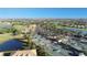 Scenic aerial view of the tennis courts, community pool, clubhouse, and golf course in River Strand at 8603 River Preserve Dr, Bradenton, FL 34212