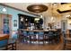 Elegant bar area featuring a circular bar, pendant lighting, and comfortable seating in the clubhouse at 8603 River Preserve Dr, Bradenton, FL 34212