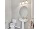 Simple half-bathroom includes pedestal sink, toilet, and neutral colors, ensuring a clean, efficient space at 8603 River Preserve Dr, Bradenton, FL 34212