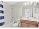 Bright bathroom features a shower and tub combination, with a modern vanity and neutral tile at 8603 River Preserve Dr, Bradenton, FL 34212