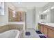 Well-appointed bathroom featuring a soaking tub, a glass-enclosed shower, and double sinks at 8603 River Preserve Dr, Bradenton, FL 34212