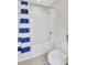 Clean bathroom featuring a tub with a shower, white tiles, and a modern toilet and vanity area at 8603 River Preserve Dr, Bradenton, FL 34212