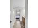 Hallway leading to a bedroom featuring a full bathroom with a tiled floor, a vanity, and neutral decor at 8603 River Preserve Dr, Bradenton, FL 34212