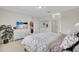 Tranquil bedroom featuring neutral colors, a view to the kitchen, and a modern entertainment center at 8603 River Preserve Dr, Bradenton, FL 34212