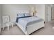 Bright bedroom with a white bed frame, soft bedding, ample natural light, and a cozy chair at 8603 River Preserve Dr, Bradenton, FL 34212