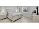 Cozy bedroom featuring a beach-themed decor, neutral colors, a window, and stylish bedside lamps at 8603 River Preserve Dr, Bradenton, FL 34212