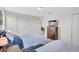 Comfortable bedroom featuring two twin beds, a dresser with a TV, and plenty of closet space at 8603 River Preserve Dr, Bradenton, FL 34212