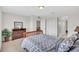 Comfortable bedroom featuring a wooden bed frame, patterned bedding, dresser, and ample natural light at 8603 River Preserve Dr, Bradenton, FL 34212