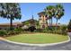 Clubhouse with well-maintained landscaping and an American flag, surrounded by lush greenery and palm trees at 8603 River Preserve Dr, Bradenton, FL 34212