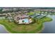 Aerial view of community pool and outdoor lounge area, surrounded by lush landscaping at 8603 River Preserve Dr, Bradenton, FL 34212