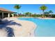 Relax by the community's stunning pool with plenty of seating, lush landscaping, and a tiki bar at 8603 River Preserve Dr, Bradenton, FL 34212