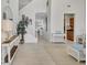 Bright foyer with staircase, tile flooring, and an open floor plan at 8603 River Preserve Dr, Bradenton, FL 34212