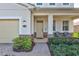 Inviting front porch with stone accents, seating, and meticulously maintained landscaping at 8603 River Preserve Dr, Bradenton, FL 34212