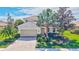 Charming single Gathering home showcasing lush landscaping and a brick driveway at 8603 River Preserve Dr, Bradenton, FL 34212