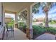 Cozy front porch with seating, brick columns, and lush landscaping at 8603 River Preserve Dr, Bradenton, FL 34212