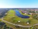 Aerial view of a golf course and luxury homes in a gated community with beautiful landscaping at 8603 River Preserve Dr, Bradenton, FL 34212
