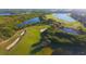 Scenic aerial view of the community's golf course featuring sand traps, green fairways, and water features at 8603 River Preserve Dr, Bradenton, FL 34212