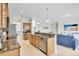 Modern kitchen with granite countertops and stainless steel appliances with open floor plan at 8603 River Preserve Dr, Bradenton, FL 34212