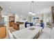 Open concept kitchen and living room with breakfast bar and ample seating at 8603 River Preserve Dr, Bradenton, FL 34212