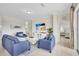 Inviting living room with blue furniture and beach-themed decor, leads to a bedroom at 8603 River Preserve Dr, Bradenton, FL 34212