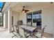 Inviting outdoor dining area with ceiling fan, and a grill, perfect for entertaining at 8603 River Preserve Dr, Bradenton, FL 34212