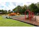 Community playground featuring colorful play structures, swings, and benches with a great view at 8603 River Preserve Dr, Bradenton, FL 34212