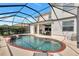 Inviting pool area with spa, screened-in for year-round enjoyment, and outdoor dining area for entertaining guests at 8603 River Preserve Dr, Bradenton, FL 34212