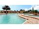 Inviting community pool with clear blue water and surrounding deck with lounge chairs and lush landscaping for relaxation at 8603 River Preserve Dr, Bradenton, FL 34212