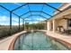 Screened-in pool and patio area with a dining set, offering the perfect blend of relaxation and outdoor dining at 8603 River Preserve Dr, Bradenton, FL 34212
