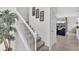Elegant staircase with white railings, leading to an upper level with a glimpse of the lake at 8603 River Preserve Dr, Bradenton, FL 34212