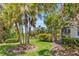 Well-maintained backyard with lush greenery, palm trees, and vibrant landscaping at 927 River Basin Ct # 201C, Bradenton, FL 34212