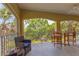 Covered balcony featuring comfortable seating and a dining table, perfect for enjoying serene outdoor views at 927 River Basin Ct # 201C, Bradenton, FL 34212