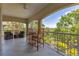 Relaxing balcony with outdoor seating offering scenic views of the surrounding lush greenery and blue skies at 927 River Basin Ct # 201C, Bradenton, FL 34212