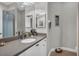 Neutral bathroom has a large mirror, decorative accents, and granite countertop at 927 River Basin Ct # 201C, Bradenton, FL 34212