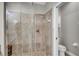 Bathroom features a glass-enclosed shower with beige tile and decorative border at 927 River Basin Ct # 201C, Bradenton, FL 34212
