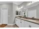 Spacious bathroom featuring double sinks, a large mirror, white cabinets, and a separate toilet area at 927 River Basin Ct # 201C, Bradenton, FL 34212