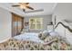 Bright bedroom with tray ceilings, a ceiling fan, and large window at 927 River Basin Ct # 201C, Bradenton, FL 34212