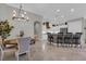 Bright dining area showcasing modern lighting fixtures, open to kitchen island at 927 River Basin Ct # 201C, Bradenton, FL 34212
