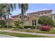 Beautiful two-story home featuring lush landscaping and a red tile roof at 927 River Basin Ct # 201C, Bradenton, FL 34212