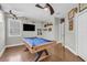 This game room has a pool table, mounted TV, and airplane decor at 927 River Basin Ct # 201C, Bradenton, FL 34212