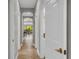 Bright hallway featuring neutral walls, tile flooring and access to a screened-in outdoor seating area with lush outdoor views at 927 River Basin Ct # 201C, Bradenton, FL 34212
