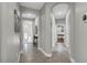 Neutral hallway featuring tiled floors, arched doorways and decoratively appointed walls at 927 River Basin Ct # 201C, Bradenton, FL 34212
