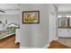 Hallway leading to a Primary bedroom and bathroom, with hardwood flooring and a serene ambiance at 927 River Basin Ct # 201C, Bradenton, FL 34212